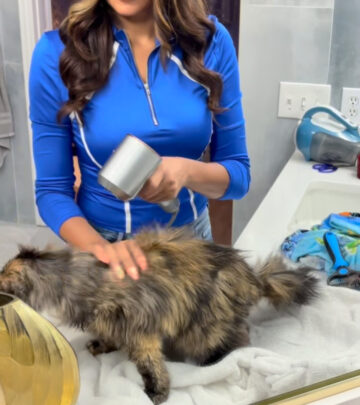 Former reality star pampers her elderly feline companion with some much-needed grooming.