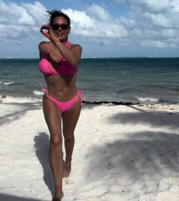 Celebrity Alex Meneses shares her beach flair with a clever nod to classic pink vibes now!