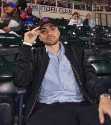 Adam enjoys a ball game and brew moment, blending sports thrills with laid-back city vibes.