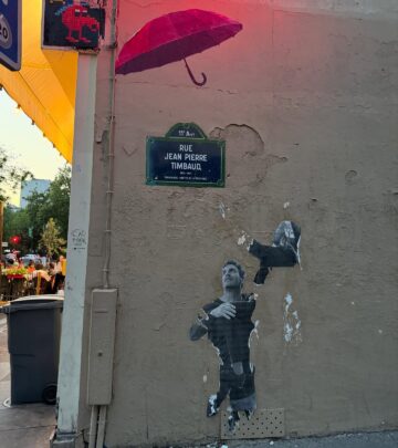Veteran actress Cady McClain delights Paris with bold style and a red umbrella scene on it.