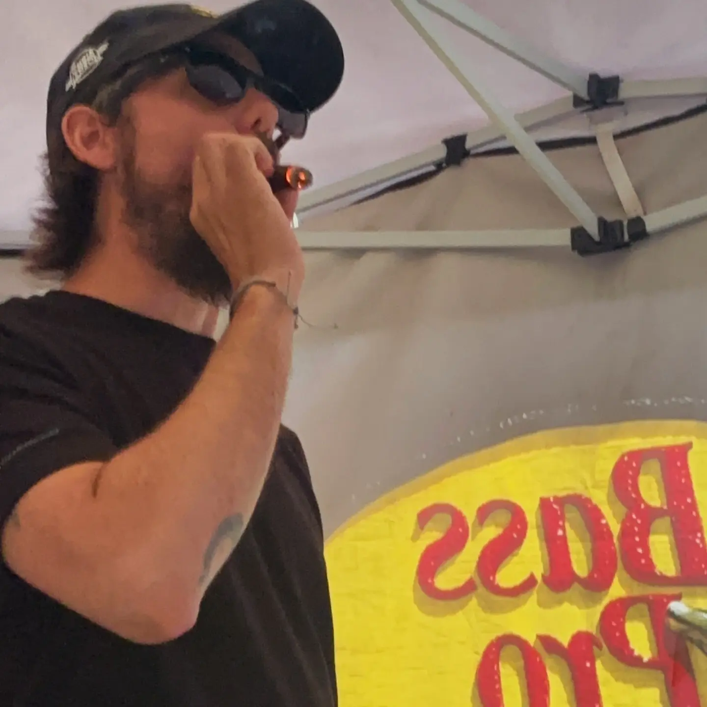 Chris Janson Blowing Smoke In Candid Snapshot Country singer Chris Janson caught blowing smoke, showcasing relaxed vibe in candid style.