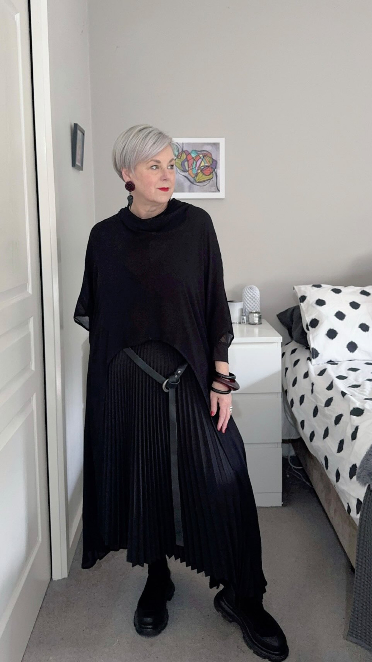 Deborah Gates unveils textured layering with modern, sleek black style for chic statement.