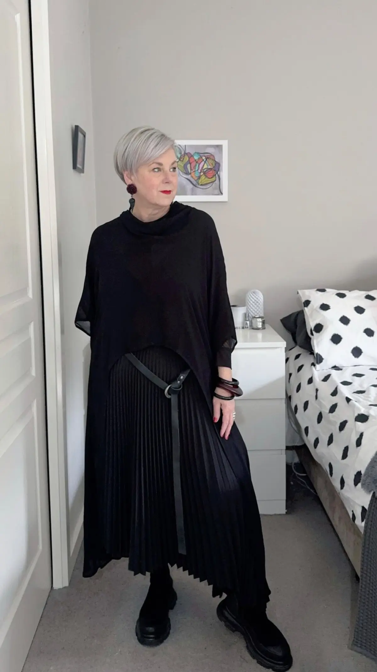 Deborah Gates unveils textured layering with modern, sleek black style for chic statement.