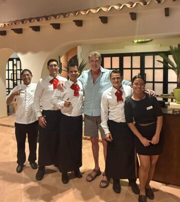 Legendary actor relishes a sumptuous Agave dinner at Excellence Coral Playa, vibrant night.