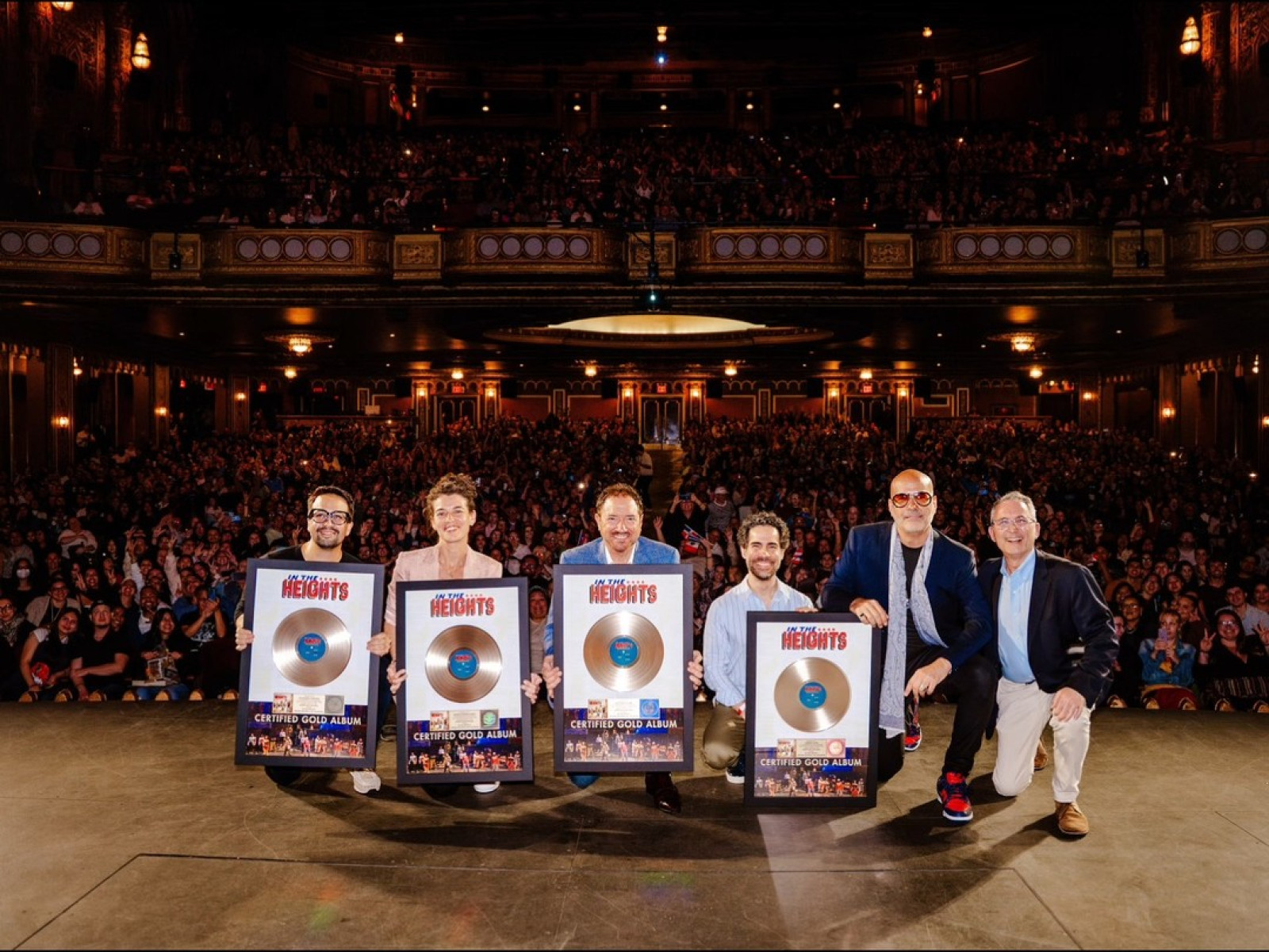 Celebrating 500K+ sales: Plaques presented to visionaries at a lively screening event.