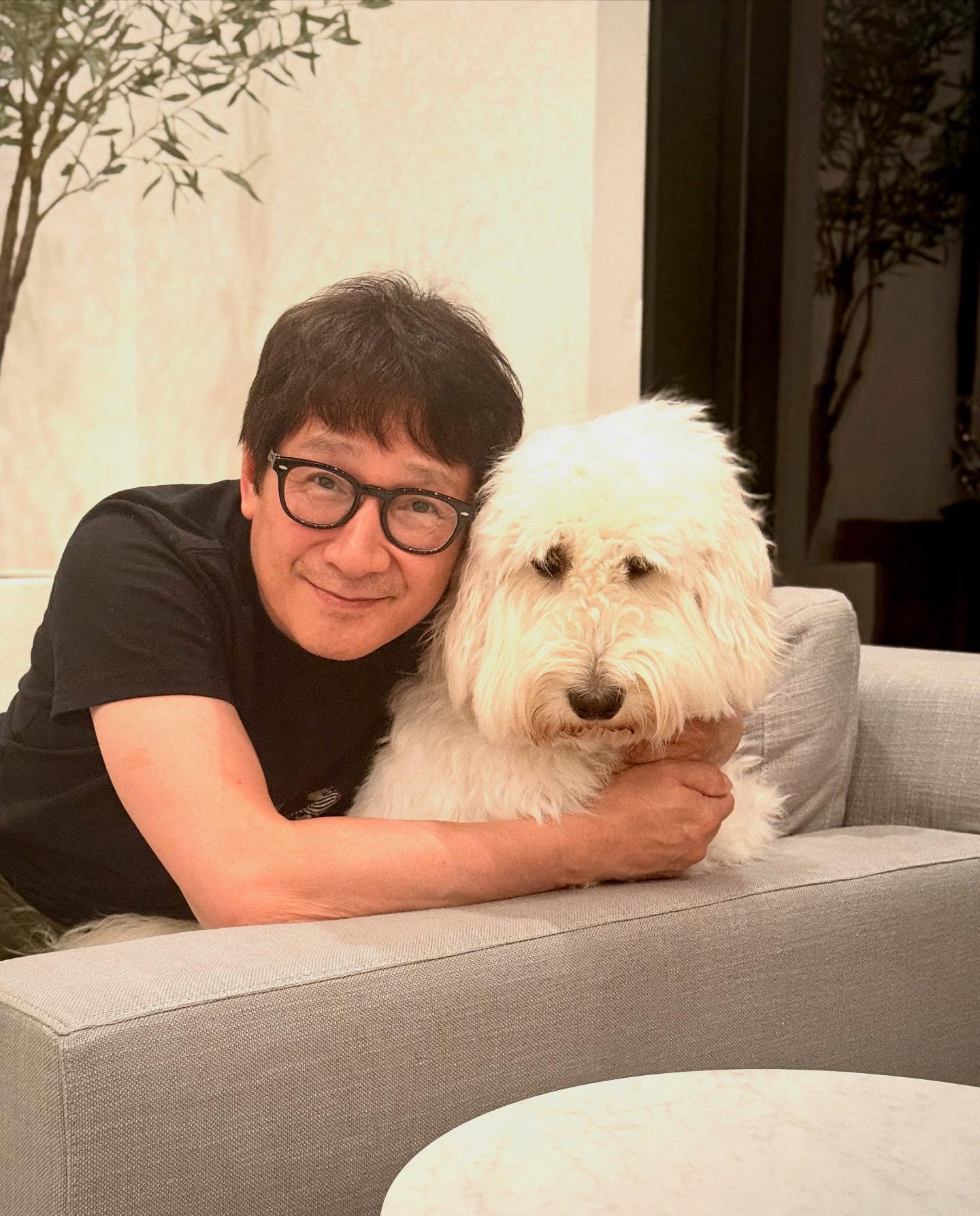 Ke Huy Quan’s Houston Cuddle Time with Dog Bagel Actor back in Houston shares sweet snaps with family’s playful new pup named after a bagel