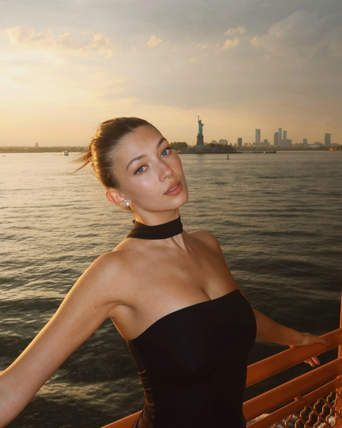 Laura Margesin Captures Golden Hour at Statue of Liberty Influencer shares breathtaking NYC sunset shots with iconic landmark glowing against dusk!