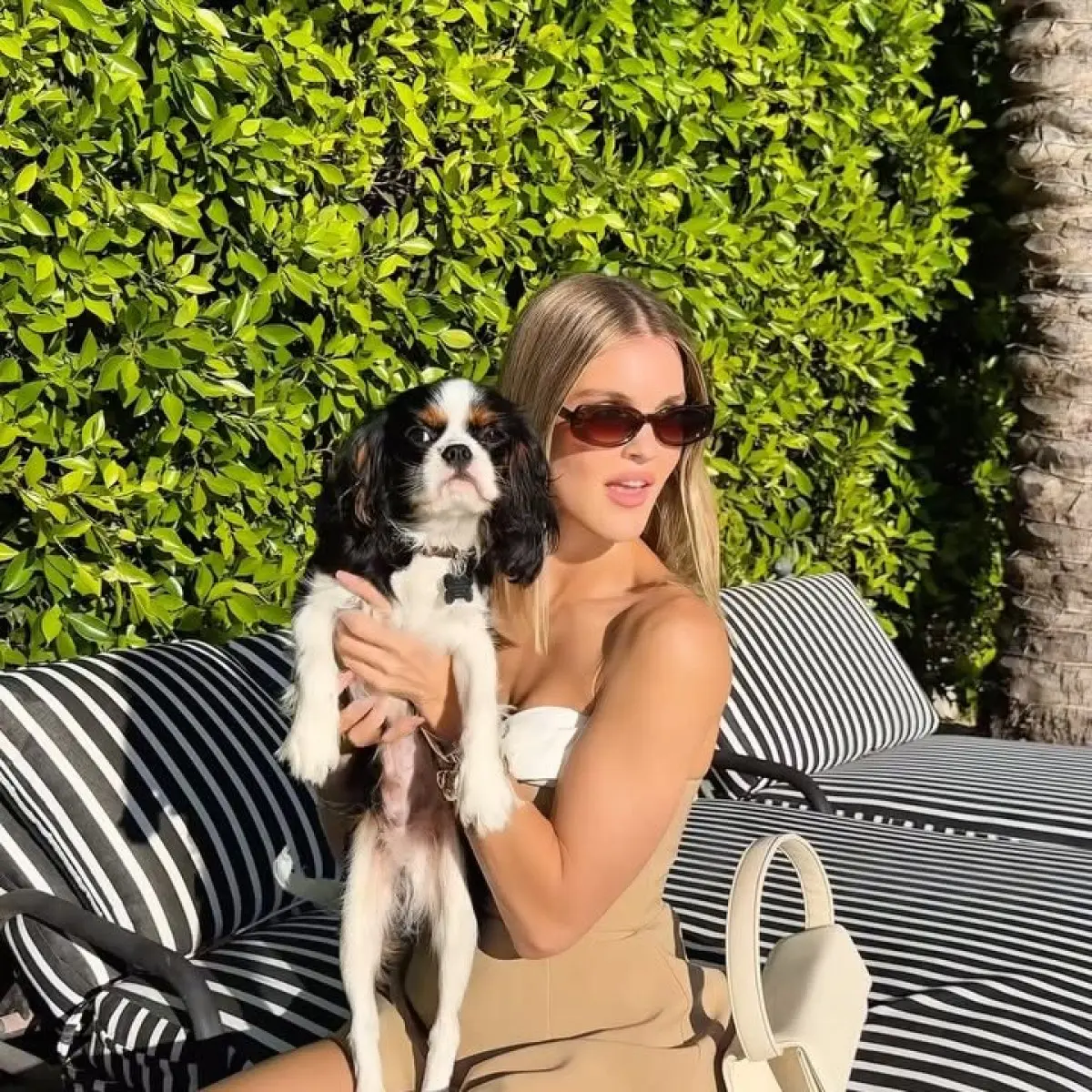 Joy Corrigan dazzles with a chic canine companion, showcasing a refined yet playful look!!