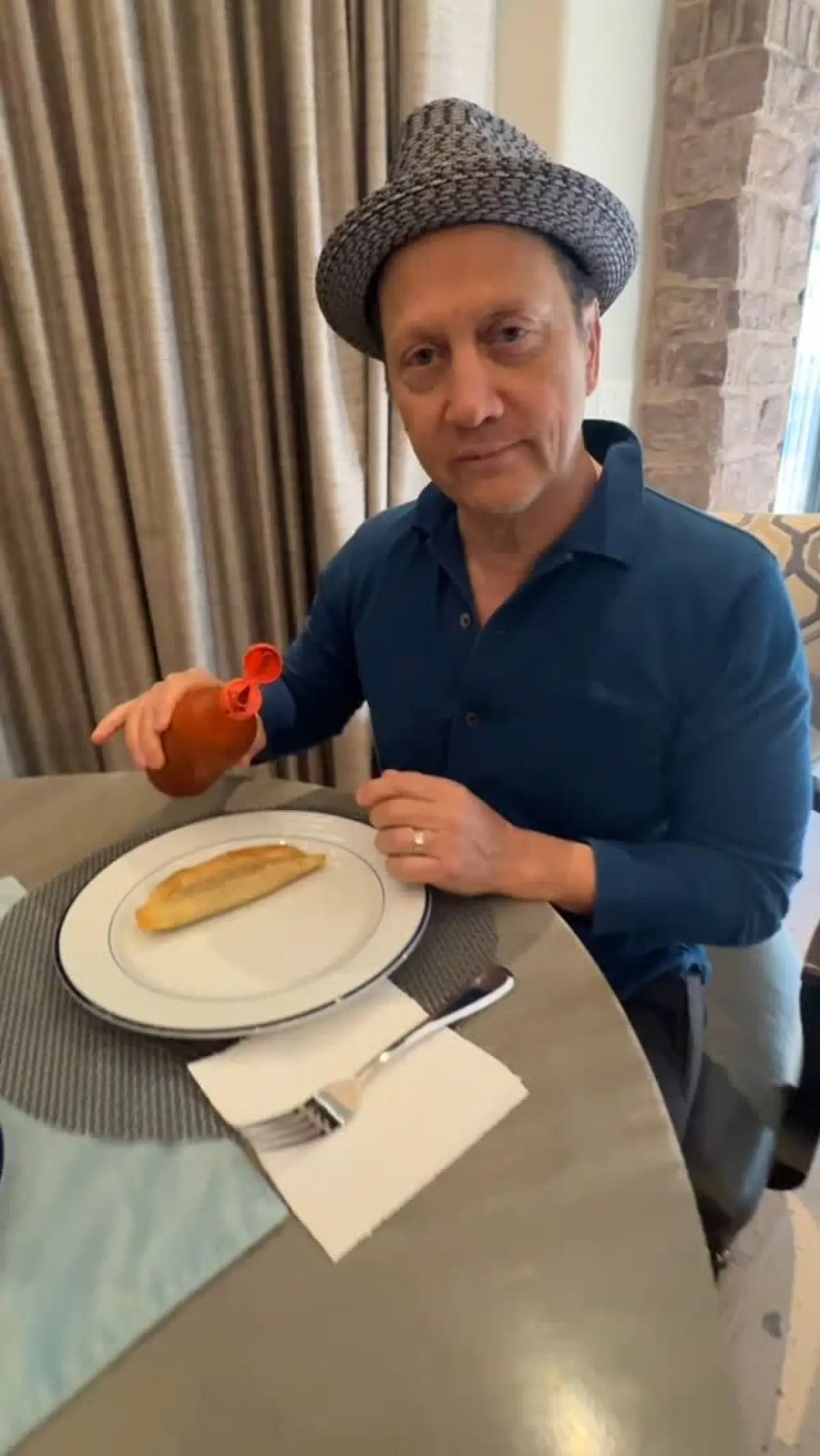 Comedian Rob Schneider savors his debut pescadilla with a spicy kick from Salsa Valentina!