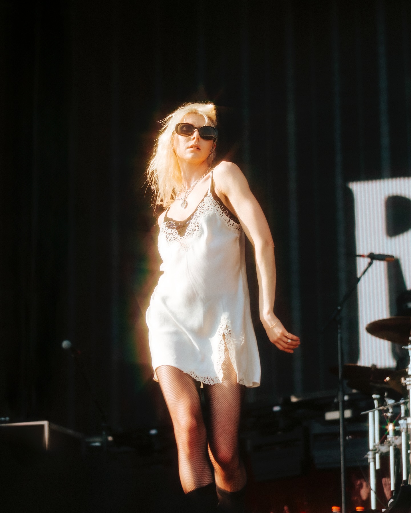 Taylor Momsen’s Haunting Visual With The Pretty Reckless A dramatic scene of moody visuals enthralls fans with raw, captivating rock energy on stage.