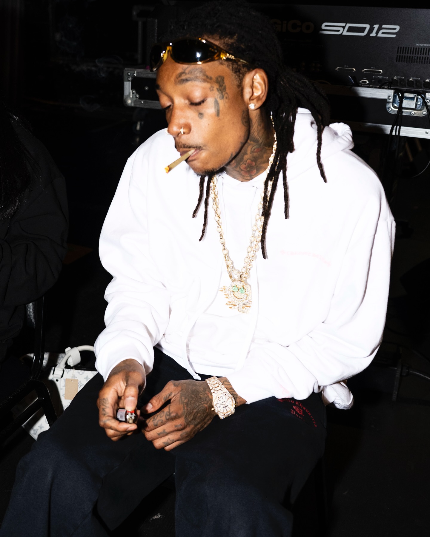 Back at his crib after promo, Wiz Khalifa engages fans with tour ideas and fresh merch now