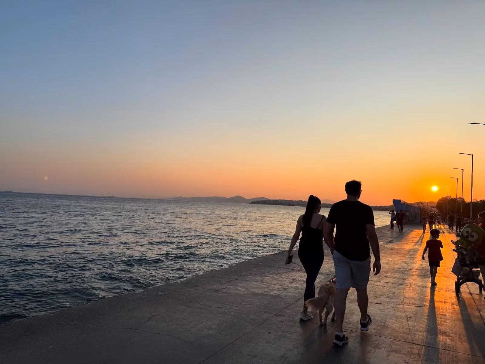 Greek harbor background creates ideal stage for seaside snaps and gourmet bites