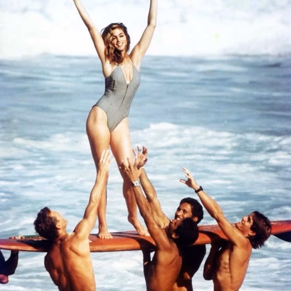 Cindy Crawford Welcomes Summer With Beachside Post Sunlit snaps atop her board capture carefree seaside moments as she rides ocean waves Yay