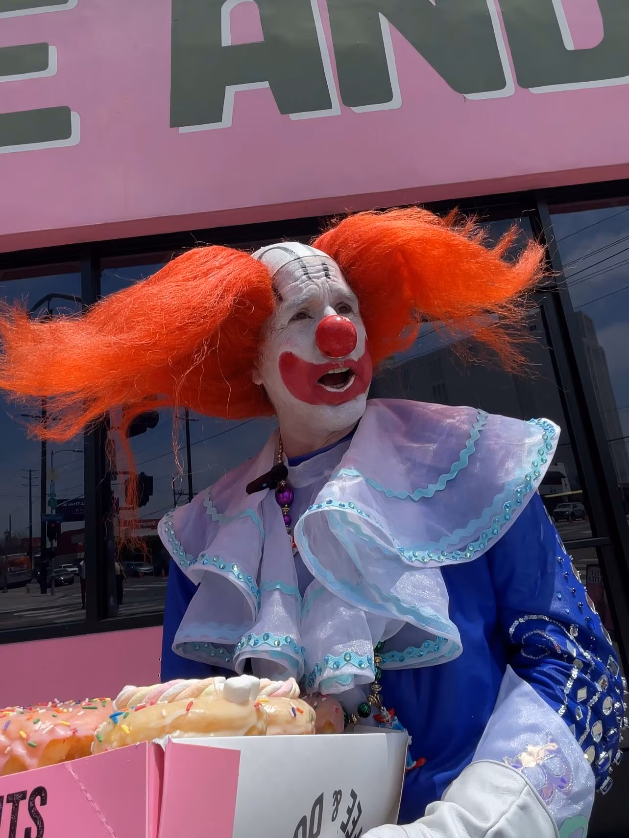 The actor-turned-clown teamed with Clownvis and Graham Wheeler sharing donuts in rainbow.