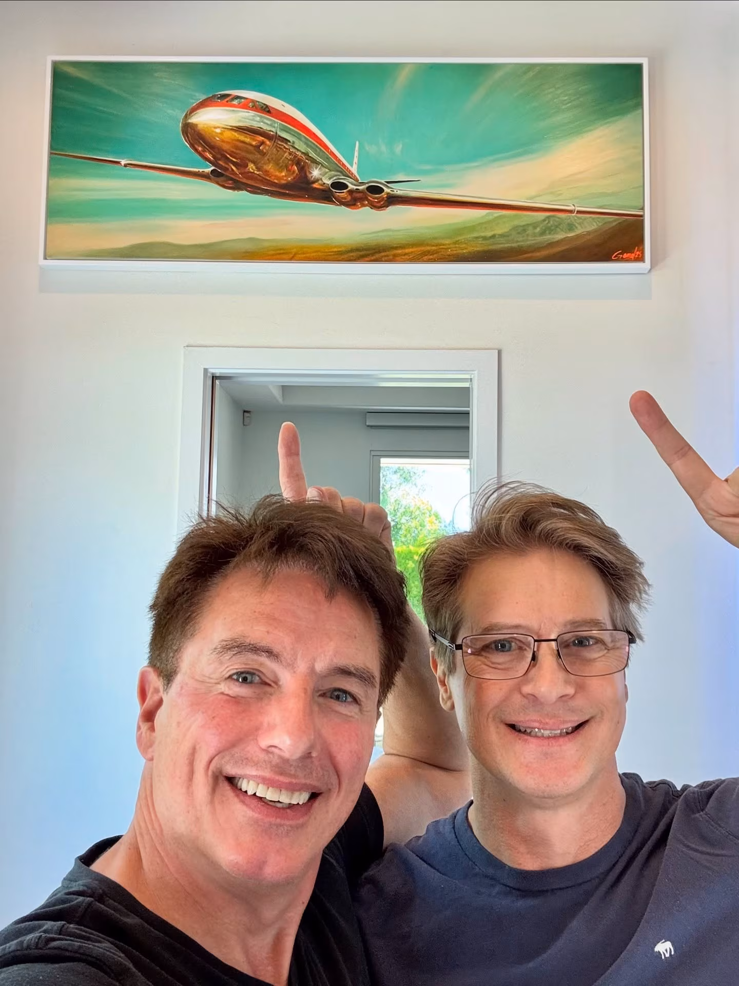 John Barrowman Gifts Husband Vintage Plane Painting A desert flight scene by Jon Gamel brings aviation charm to a Palm Springs bathroom window